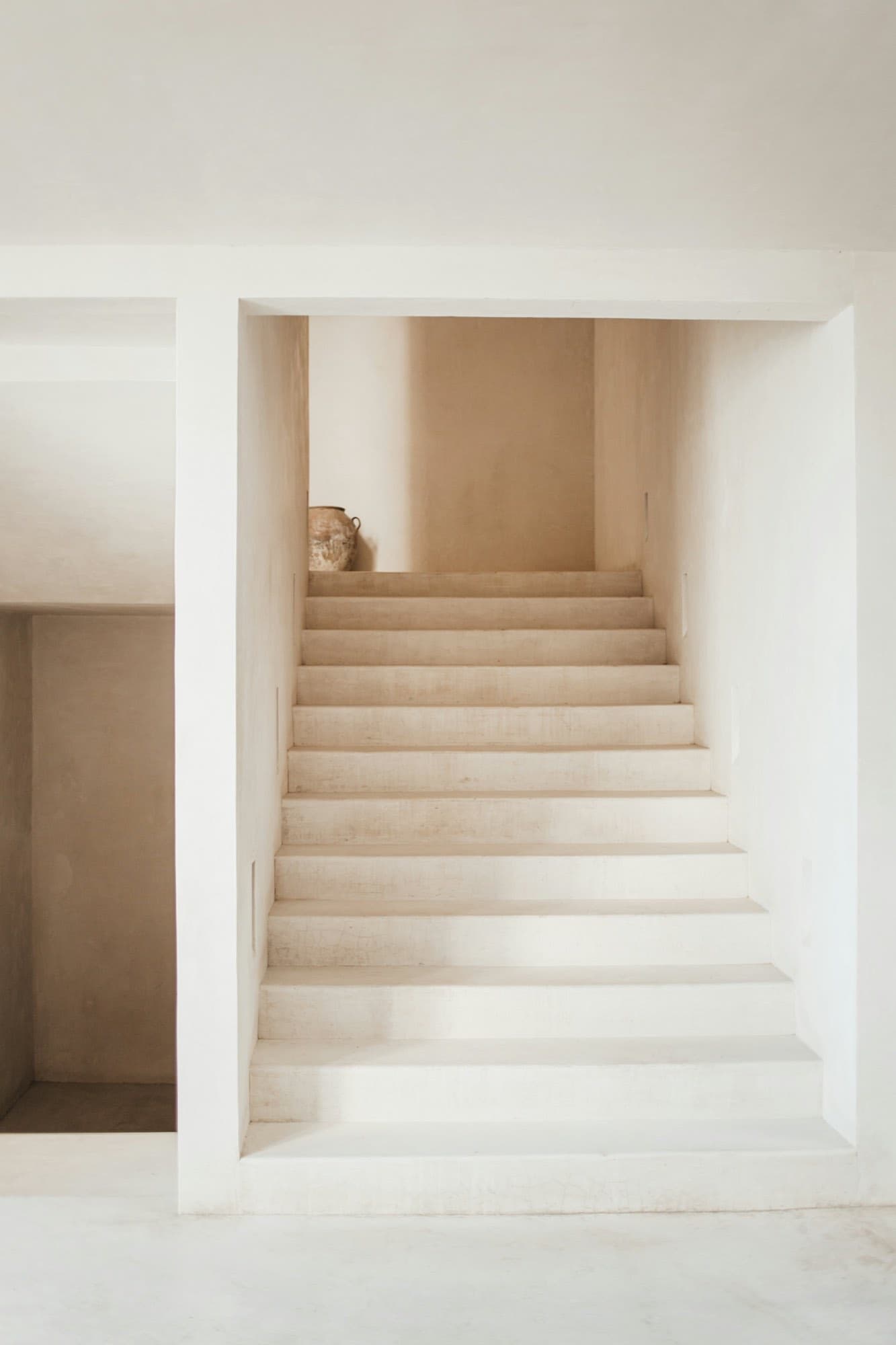 A pale stone staircase lit from above
