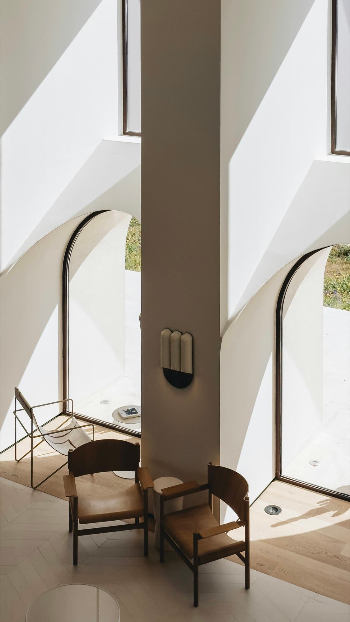 Curved white architecture cut by slim black handrails